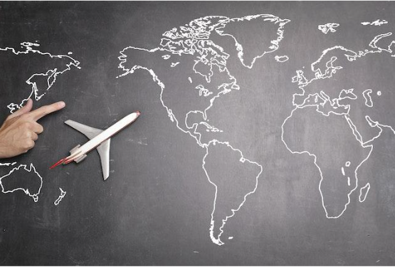 Blackboard with an outline of the world and an airplane. 