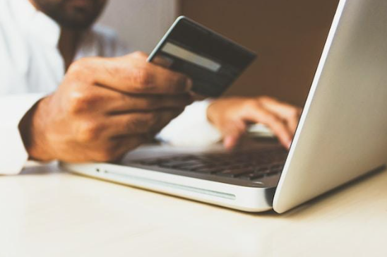 A person using a credit card for online shopping