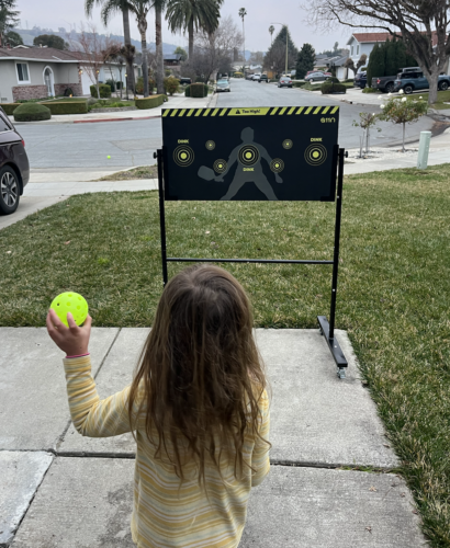 Picture of my 5 year old playing pickleball with a rebounder.